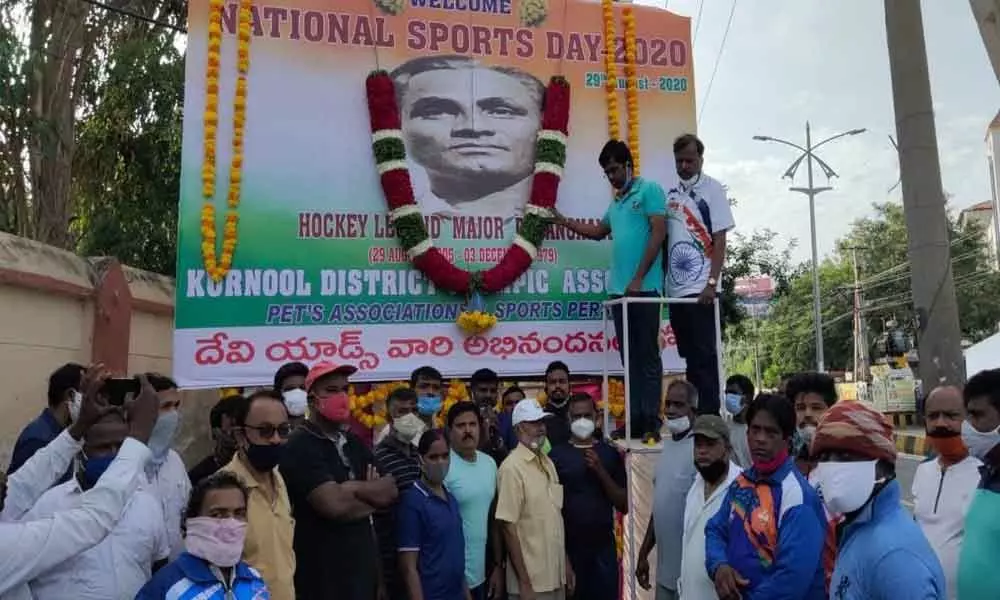 Municipal Corporation Commissioner D K Balaji garlanding to the portrait of Major Dhyan Chand on the occasion of National Sports Day at the Outdoor Stadium in Kurnool on Saturday
