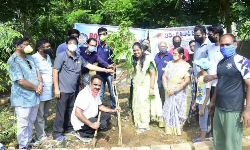 Rotary Club district wing chairman M R K Das and other rotary club members planting saplings at Rotary Vanam in Srikakulam on Sunday.
