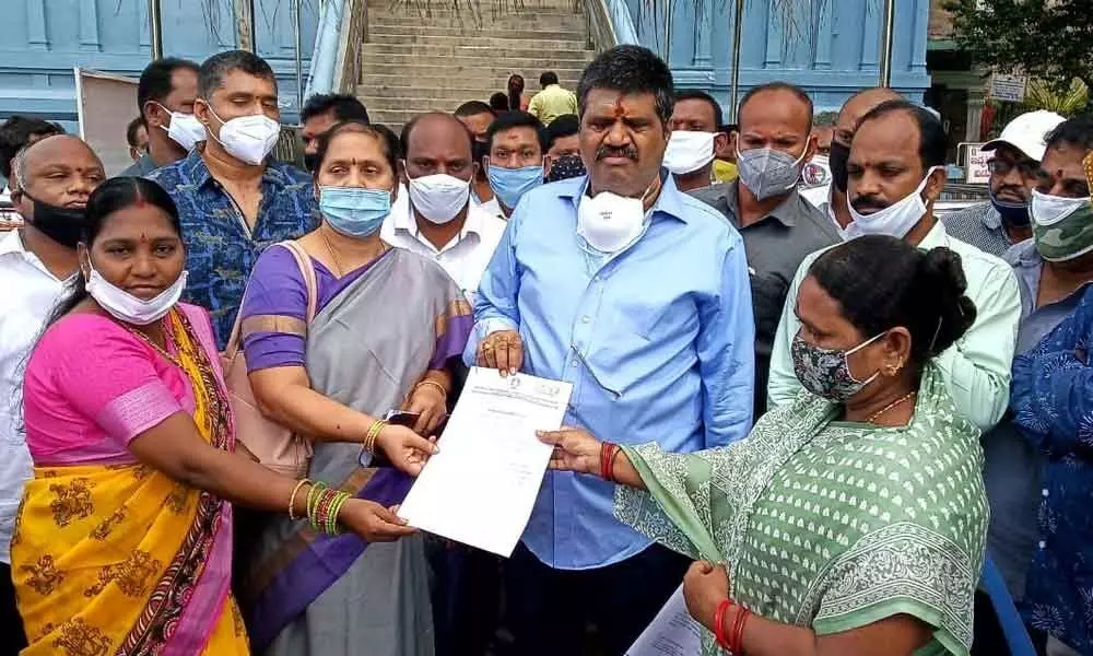 Tourism Minister M Srinivasa Rao issuing reinstatement orders on Sunday to outsourced staff whose services were earlier suspended at Simhachalam Devasthanam