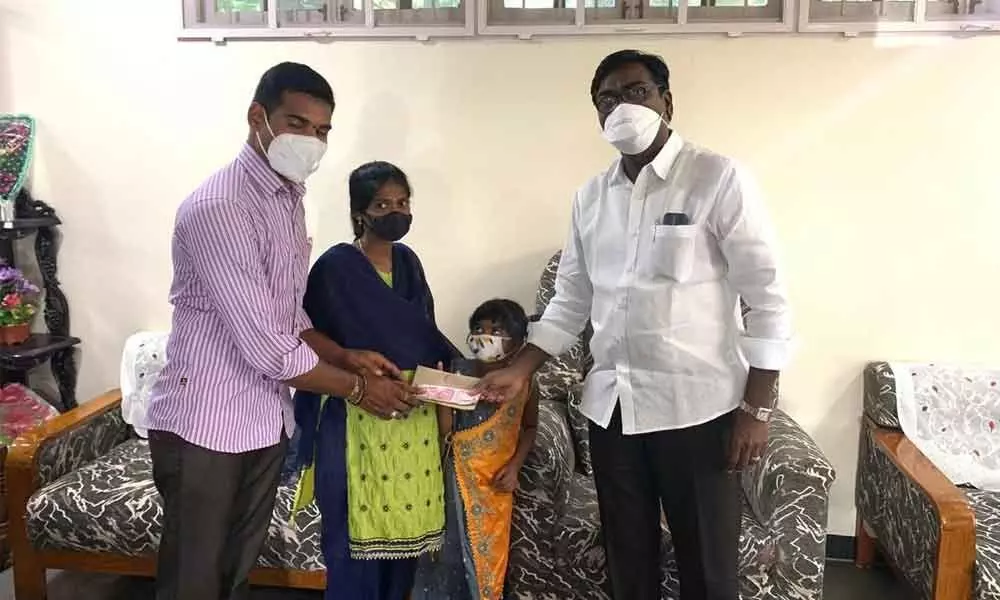 Minister Ajay donating `50,000/- to ten-year-old girl in Khammam on Sunday