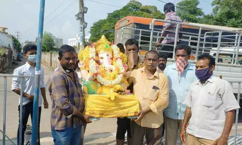 Devotees carrying a Ganesh idol for immersion in Kakinada on Monday