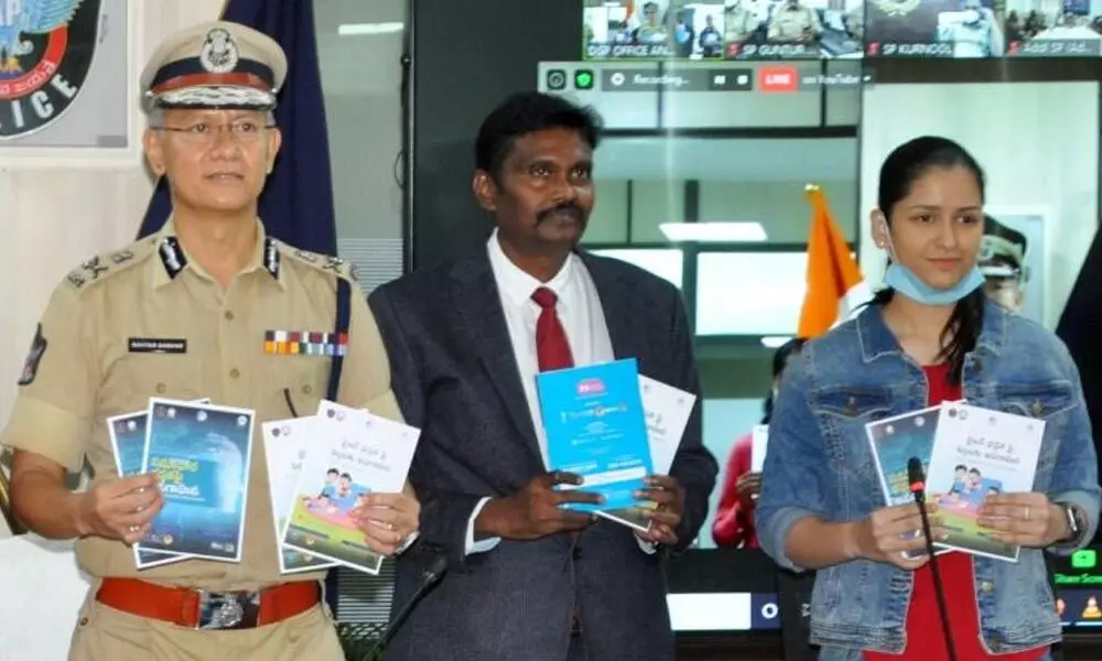 DGP D Gautam Sawang and others releasing a book on e-Rakshabandhan programme at the State police office at Mangalagiri on Monday