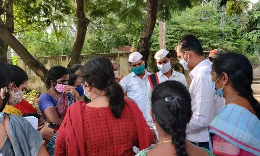 Kakinada Municipal Corporation Commissioner Swapnil Dinakar Pundkar interacting with locals about construction works in municipal primary schools on Monday