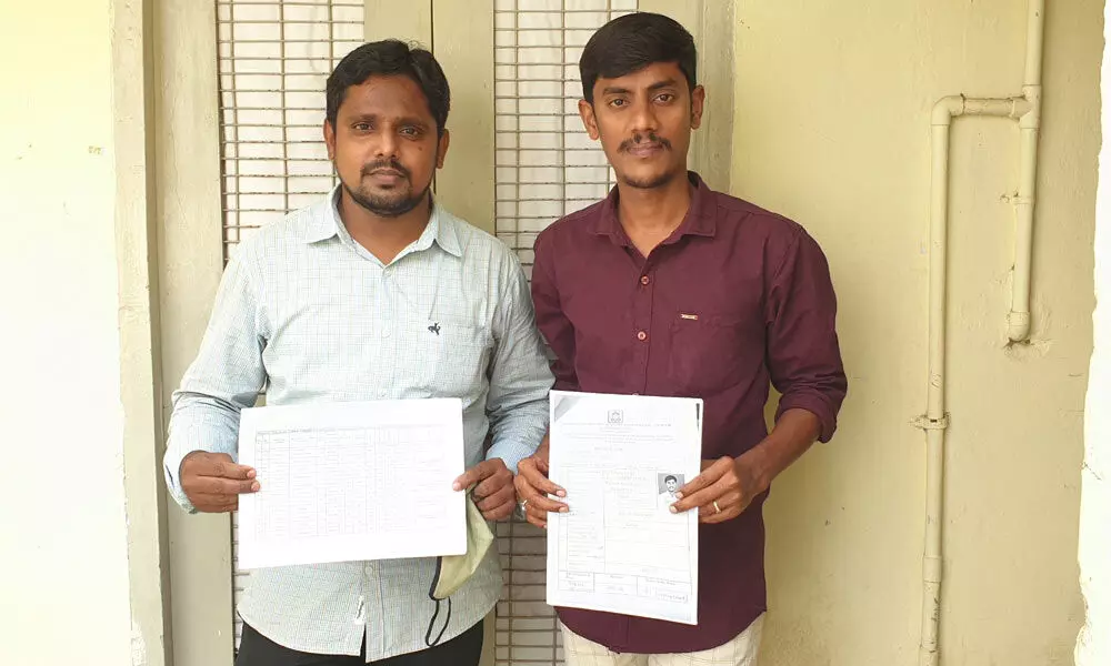 Applicants displaying faculty merit list in Lab recruitment posts in Anantapur on Monday