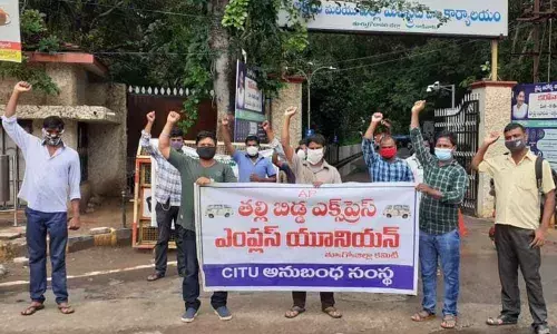 Thalli-Bidda Express Service Union workers staging dharna at Collectorate in Kakinada on Tuesday