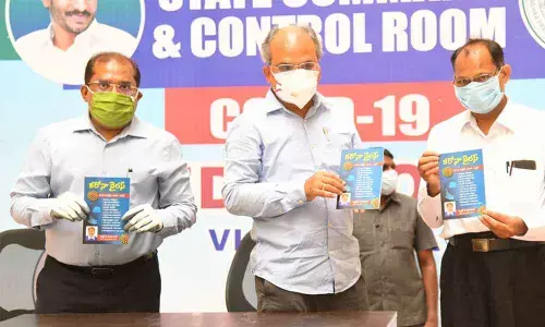 Special Chief Secretary, Medical and Health,  K S Jawahar Reddy (centre) and Krishna District Collector Md Imtiaz (Left) releasing a book Coronavirus – Mundu Jagrathale Mandu Vaidyam written by Dr T Seva Kumar (Right) in Vijayawada on Tuesday