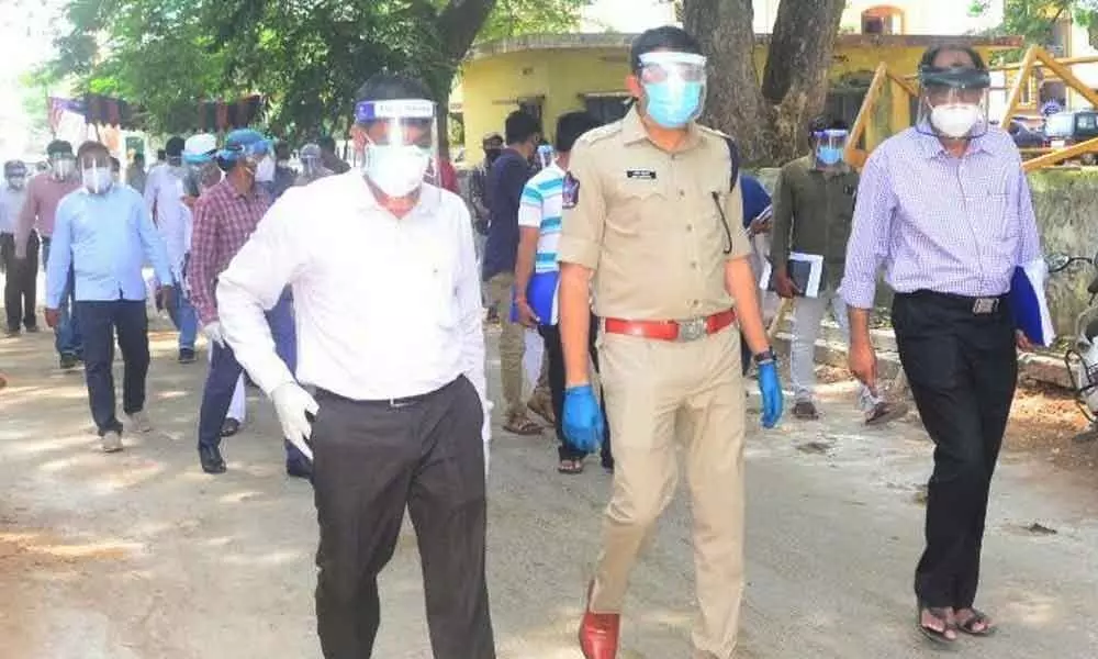 District Collector J Nivas (left), SP Amith Bardhar and Municipal Commissioner P Nallanayya inspecting containment zones in Srikakulam city on Tuesday