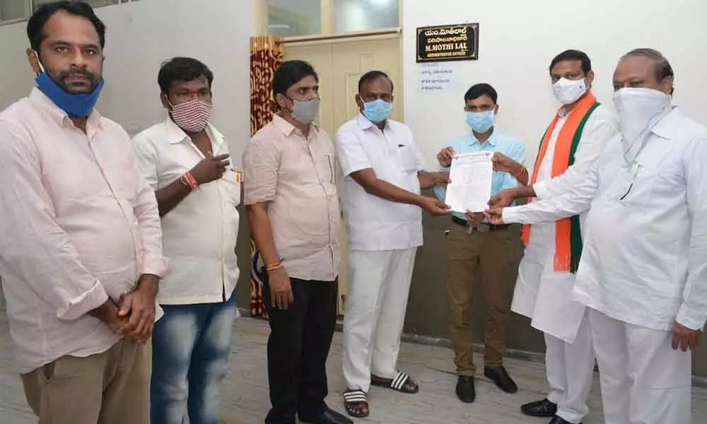 BJP district president K Sridhar Reddy along with other leaders submitting a memorandum to AO M Motilal at Nalgonda Collectorate on Wednesday