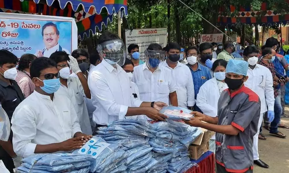 Distributing PPE kits and masks to sanitation staff