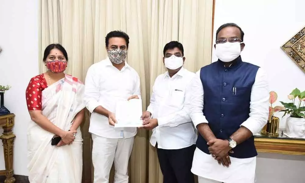 Khammam MP Nama Nageswara Rao handing over Rs 1.23 crore cheque to the Minister for Urban Development KT Rama Rao on Saturday at Hyderabad