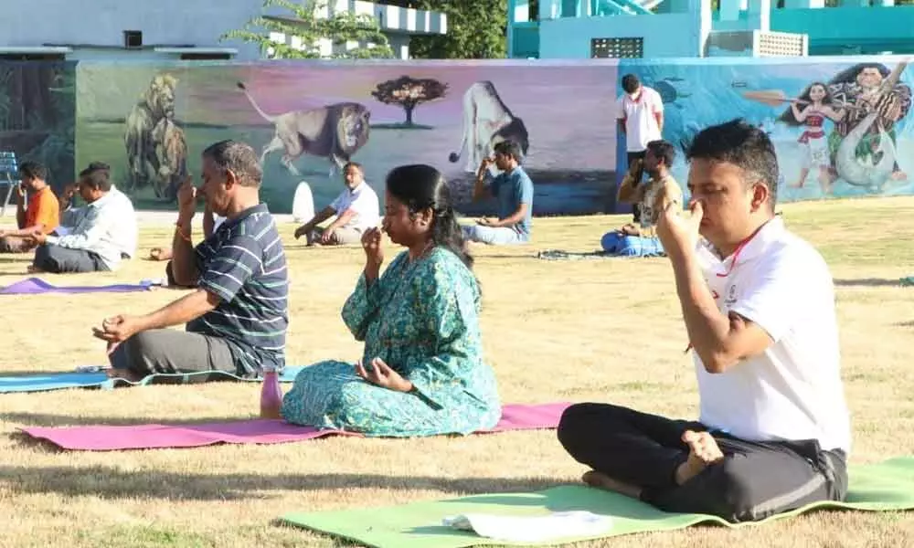 MCT Commissioner  P S Girisha and Additional Commissioner Haritha practising yoga at Municipal Park along with some denizens in Tirupati on Sunday