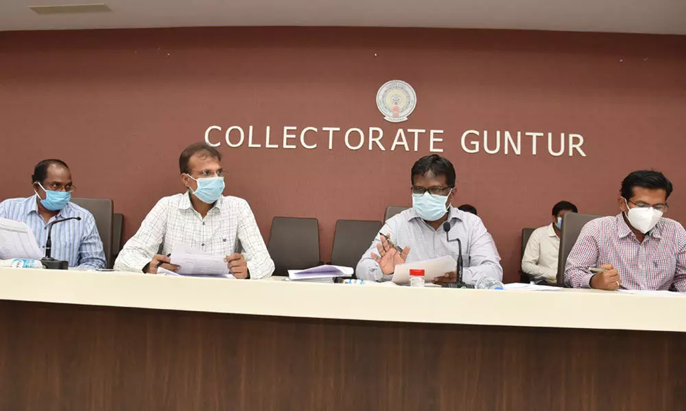 District Collector I Samuel Anand Kumar addressing a review meeting at the Collectorate in Guntur city on Monday