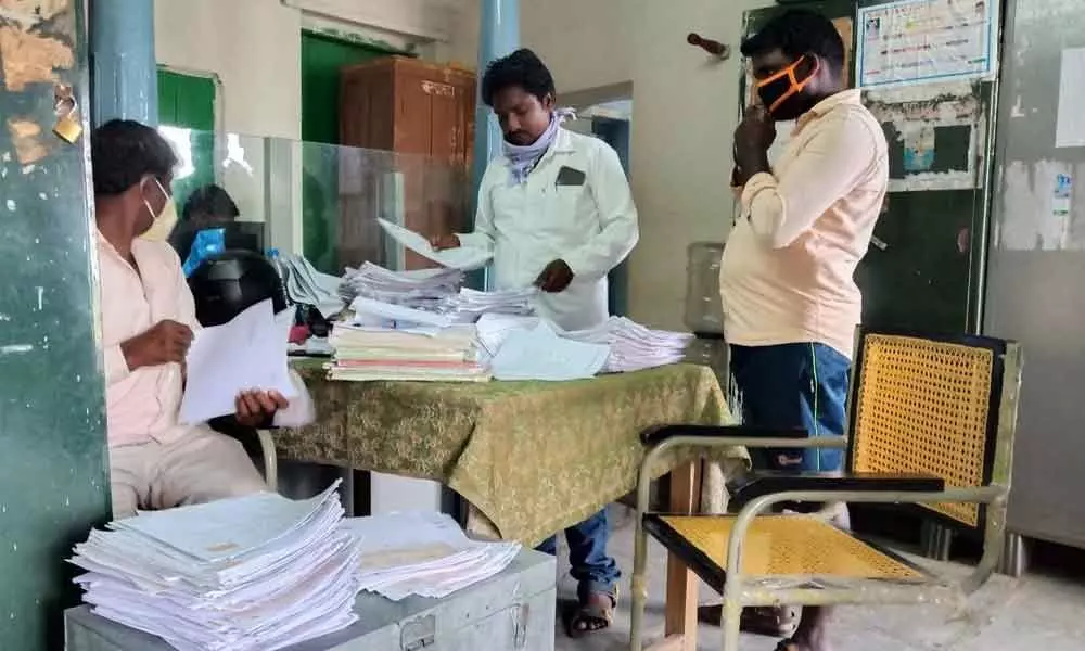 VROs of Nagarkurnool district sorting out the records of their respective villages to hand over to revenue officials on Monday