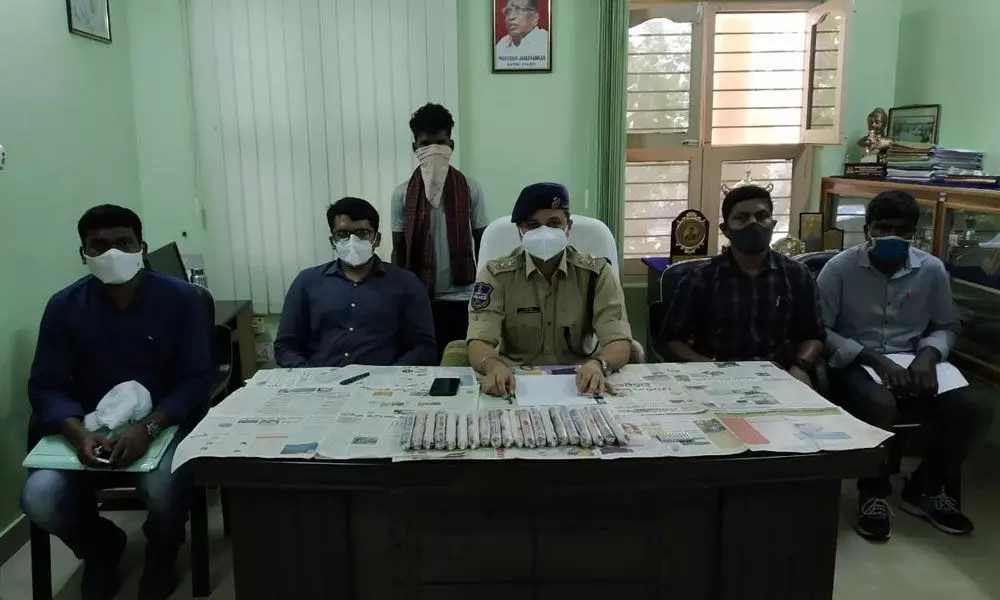 ASP Rajesh Chandra producing the arrested Maoist before the media at his office in Bhadrachalam on Tuesday