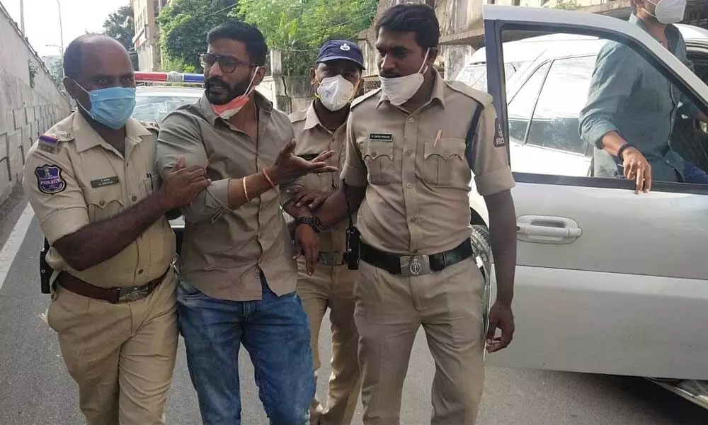 NSUI State president Venkat Balmoor being taken into custody, when he was on his way to distribute masks and sanitizers to students at EAMCET exam centre in Kukatpally on Wednesday