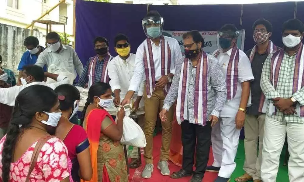 MP Margani Bharat Ram distributing essential commodity kits at Swarnandhra Seva Samsta in Rajamahendravaram on Wednesday. Samsta founder Dr Gubbala Rambabu is also seen