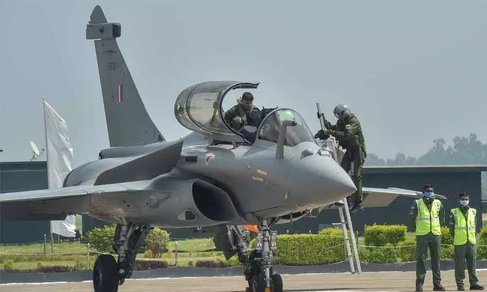 IAF pilots board a Rafale fighter aircraft during its induction into the IAF fleet, at the Ambala air base on Thursday
