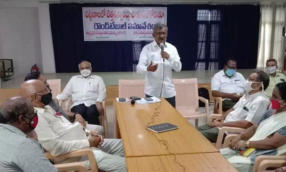 Andhra Pradesh Urban Citizens Forum convener Ch Babu Rao addressing a roundtable meeting in Vijayawada on Friday