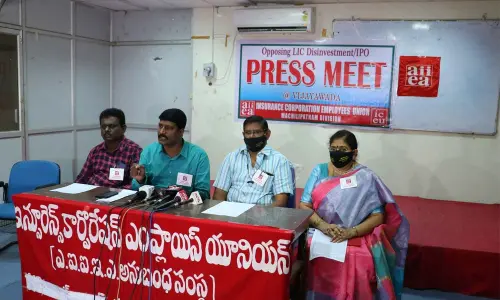 Insurance Corporation Employees Union joint secretary Dr Chilakalapudi Kaladhar and others addressing a press conference in Vijayawada on Saturday