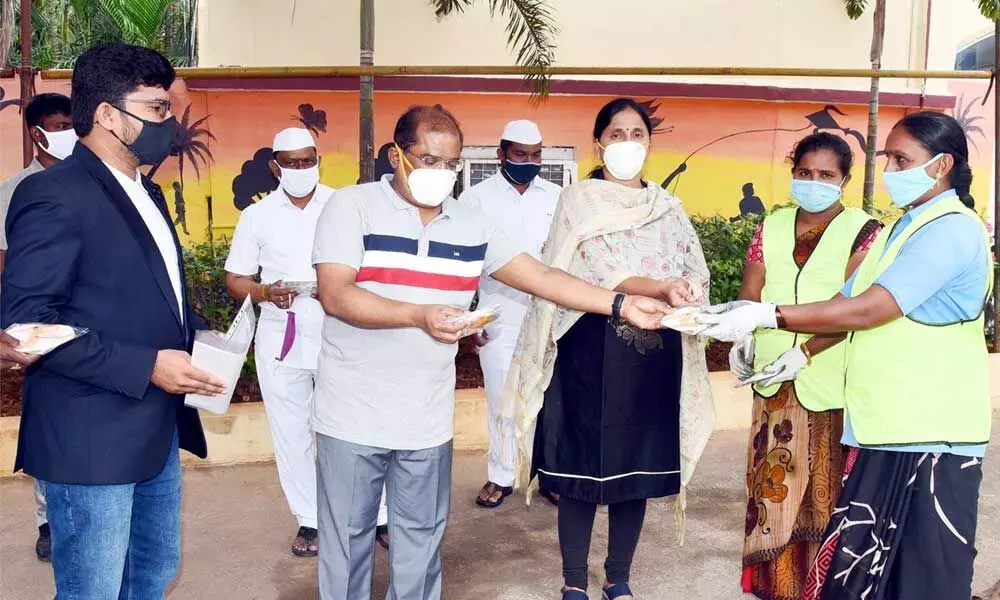 Krishna District Collector Md Imtiaz distributing masks to sanitary workers and Medical and Health Department staff at his camp office in Vijayawada on Saturday