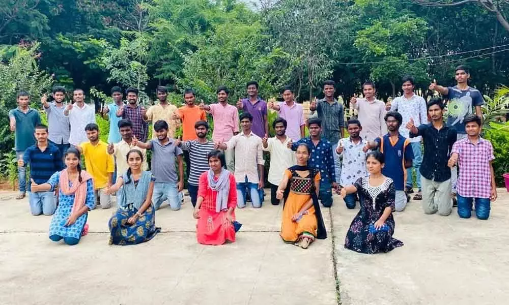 A view of the successful students posing for a group photograph
