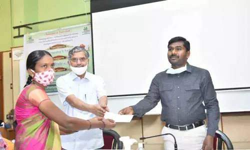 Collector Gandham Chandrudu disburses cheques of financial help to women labourers, in Anantapur on Sunday