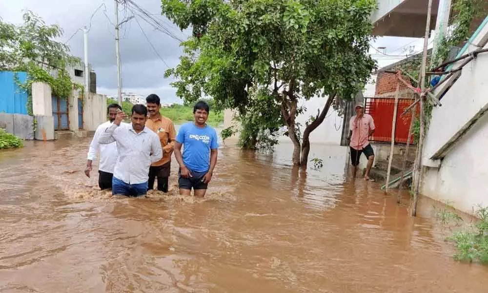 With incessant rains lashing the district, a residential colony submerged in knee-deep waters in Nandyal on Sunday