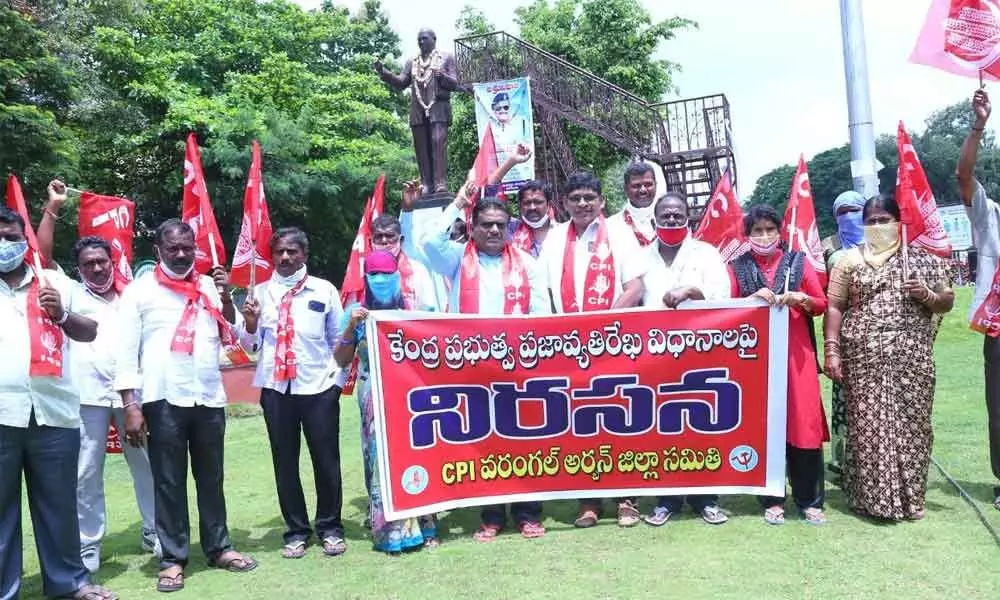CPI workers staging protest near Ambedkar statue in Hanamkonda on Monday