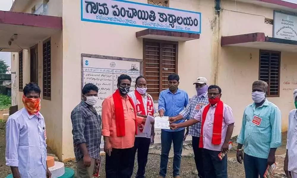 AITUC and IFTU leaders submitting a memorandum to Raghunadhapalem gram panchayat secretary M Prasanna Kumar in Khammam on Monday