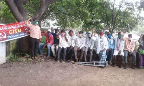 Gram panchayat workers staging a protest in front of Bodhan MPDO office on Wednesday