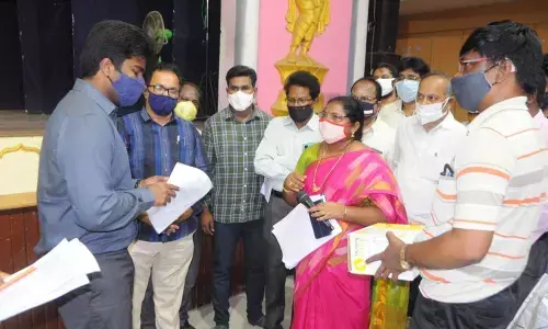 Municipal Commissioner Abhishikt Kishore enquiring about distribution of exam material in Rajamahendravaram on Friday