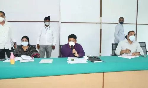 MCT Commissioner P S Girisha conducting a review meeting with officials on village secretariat exams in Tirupati on Friday