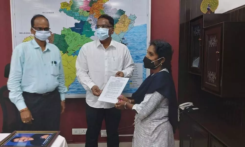 Principal Chief Conservator of Forests N Prateep Kumar handing over appointment letter to Durga Devi at forest circle office in Rajamahendravaram on Friday