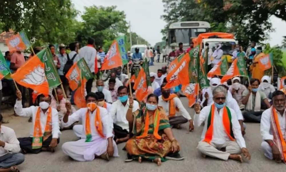 BJP workers staging a sit-in protest at Bichkunda-Banswada road in Bandarenjal village in Jukkal constituency on Saturday