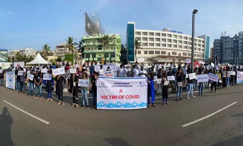 Event managers carry out a silent protest at YMCA, Beach Road, in Visakhapatnam on Saturday