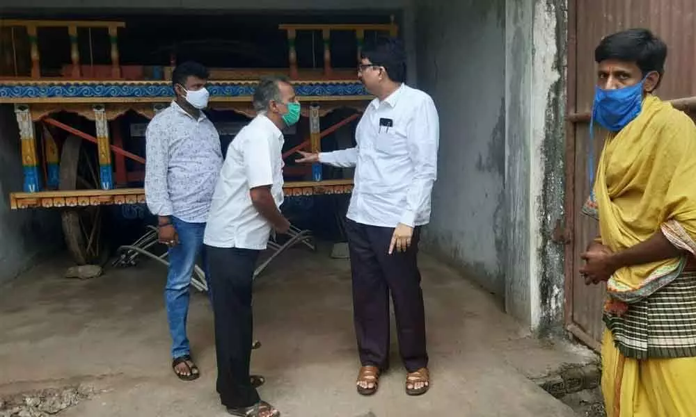 Endowments Assistant Commissioner V Hari Suryaprakash (right) giving instructions to temple staff (left) at Jagannadha Swamy temple in Itchapuram on Sunday regarding safety measures