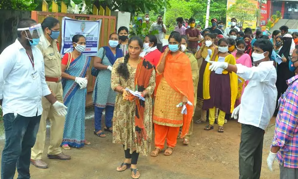 Candidates attending the exam at a centre in Vijayawada on Sunday