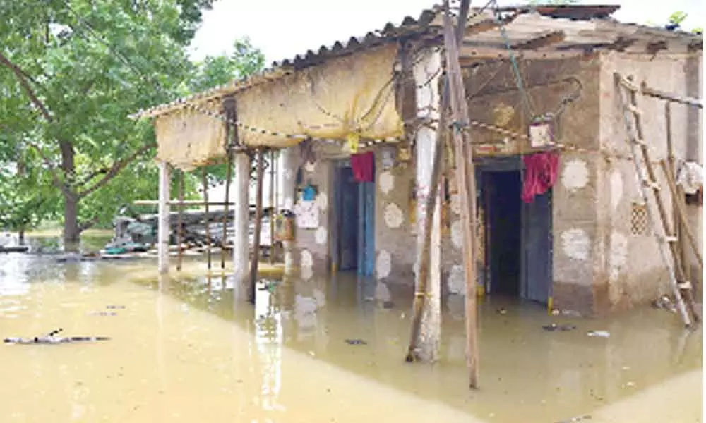 Floodwater entering houses at Ranigari Thota in Vijayawada on Sunday