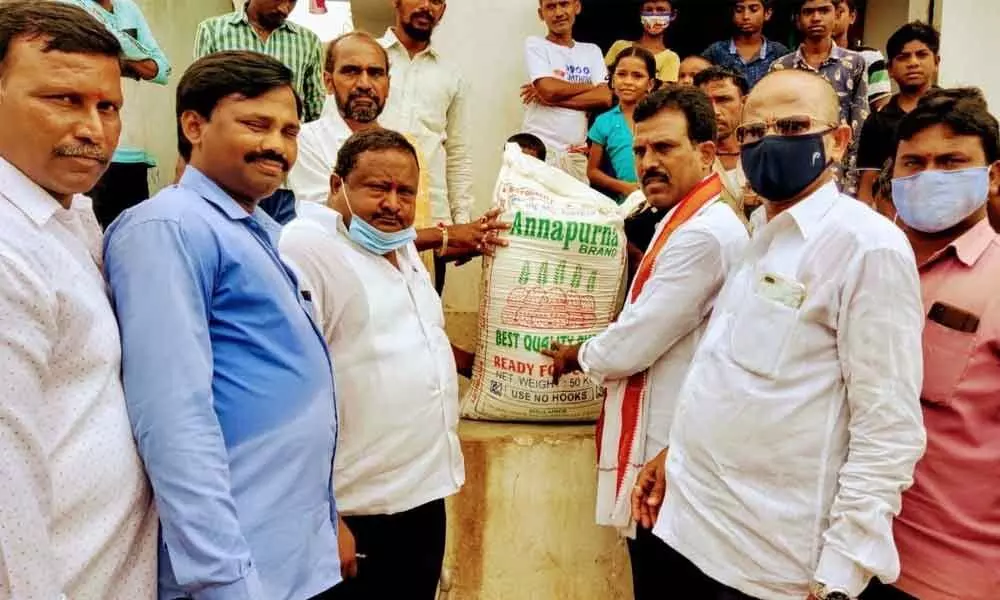 TPCC secretary from Devarkadra mandal G Madhusudhan Reddy distributing 10 kg rice to the flood-affected people in Appampally village on Sunday