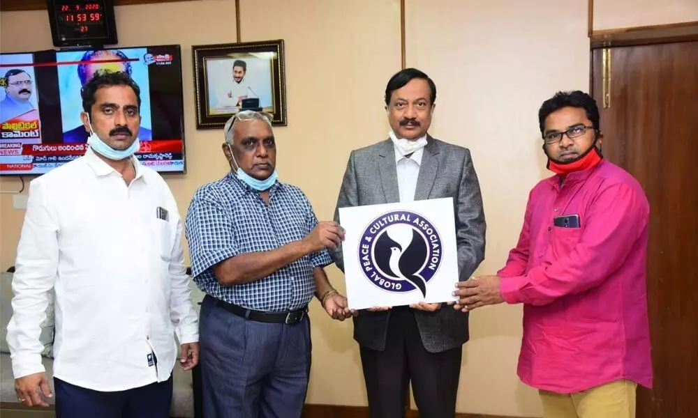 Nannaya University Vice-Chancellor Prof M J Rao releasing a logo of Global Peace and Cultural Association at his office in Rajamahendravaram on Tuesday. Registrar D BG Rao and Addanki Raja Yohna are also seen.