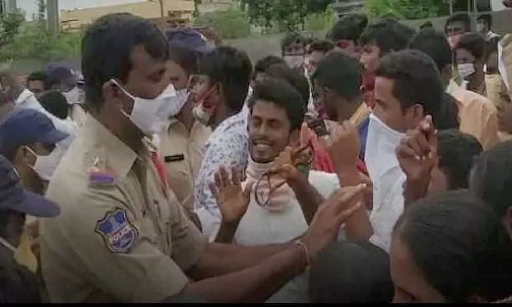 Police reasoning with the villagers, who were staging a protest in front of the police station in Karepalli on Tuesday