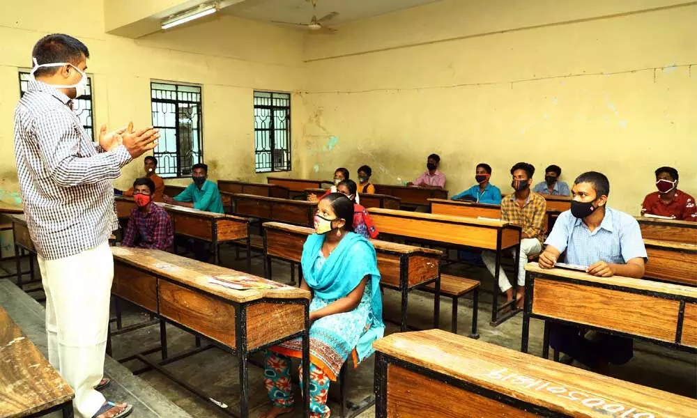 Students wearing masks and maintaining physical distance attend classes at  SV High school in Tirupati on Tuesday