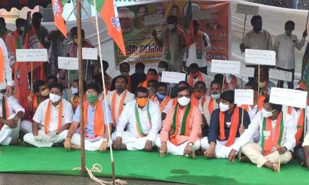 BJP district president Baswa Lakshmi Narsaiah and leaders staging a dharna in front of District Collectors office in Nizamabad on Tuesday