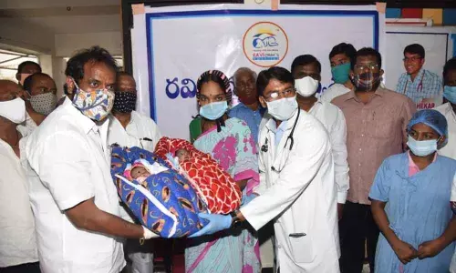 Dr Sekhar handing over the twin girls to Excise and Prohibition Minister Srinivas Goud at Ravi Children’s Hospital in Mahabubnagar on Tuesday. The twins’ mother Krishnaveni also seen