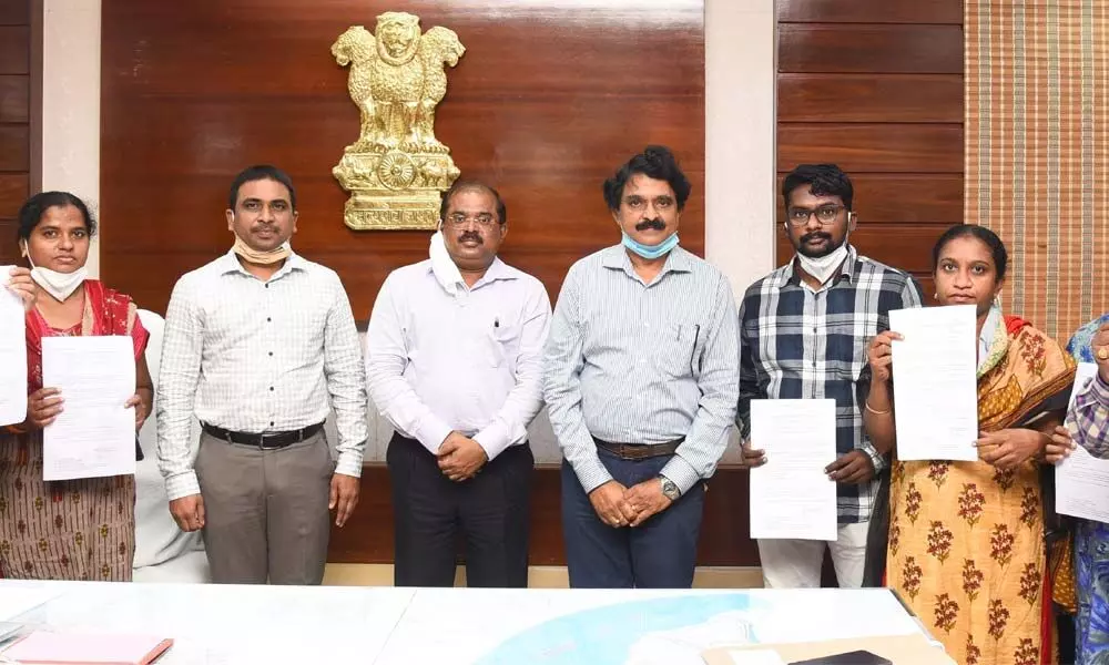 Krishna district Collector Md Imtiaz with newly-recruited staff at the camp office in Vijayawada on Thursday