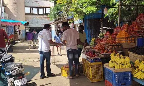 VNR Charitable Trust chief Dr Naveen Vallam explaining to the people Covid-19 precautions they should take to protect themselves in Kamareddy on Thursday