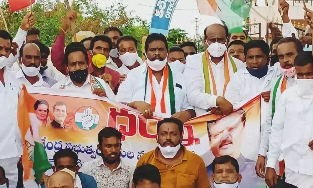 DCC president K Srinvas Rao and leaders staging a dharna in front of District Collectorate in Kamareddy on Friday