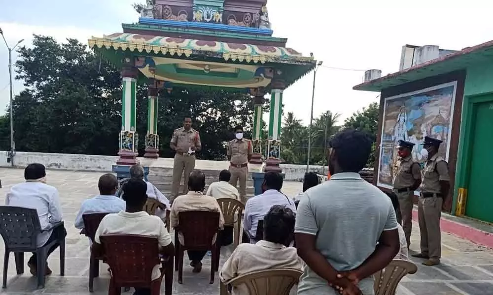 Circle Inspector Abdul Nabi speaking to protection force committee members at Ramalayam in Gudivada rural police station limits