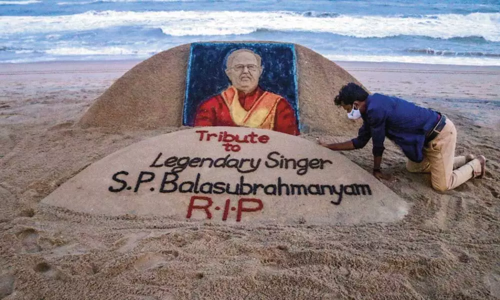 Sand artist Sudarsan Pattnaik gives final touch to a sand sculpture at Puri beach in memory of legendary singer S P Balasubrahmanyam who passed away on Friday