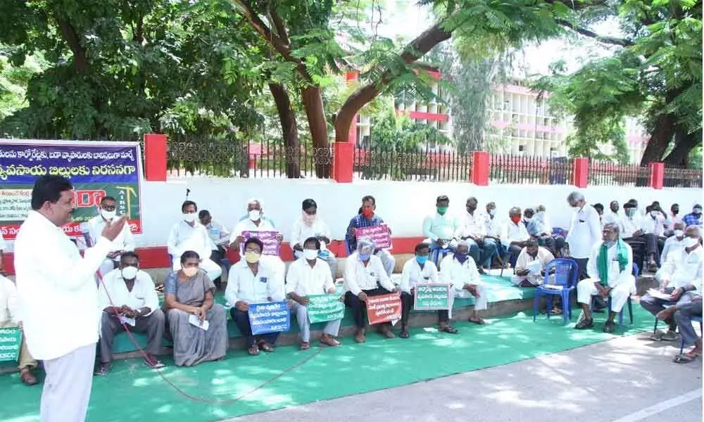 Farmers staging a protest in front of the Collectorate in Ongole on Friday